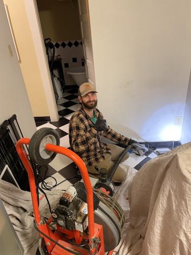 John Journeyman Plumber Augering Pipes